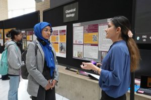 A photo of 2 students talking at the Career Expo. 