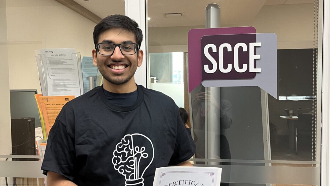 Photo of student holding a certificate.